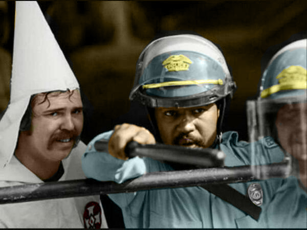 1983-e28093-austin-texas-this-policeman-protects-kkk-members-during-a-rally-as-protestors-were-closing-in-on-them