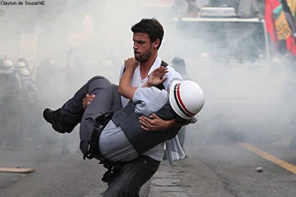 brazilian-protester-carrying-an-injured-officer-to-safety-sao-paulo-brazil-2012